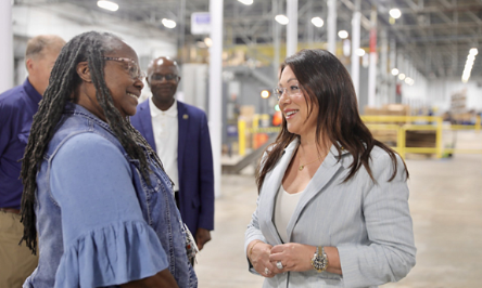 Secretary Chavez-DeRemer speaks with a female worker in a warehouse.