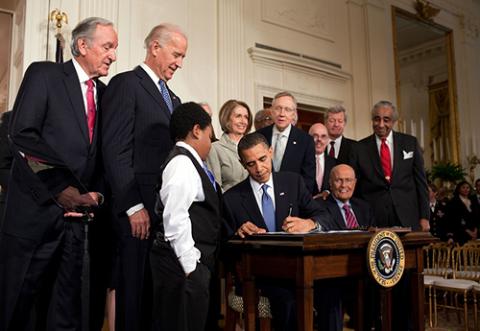 President Obama signing ACA into law