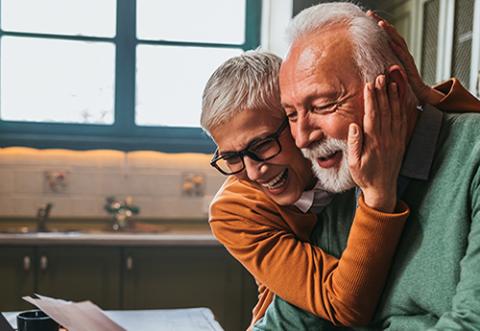 A happy elderly couple looking at a piece of paper