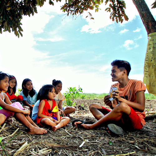 Glenn teaching village students