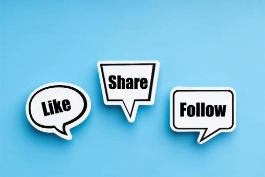 Showing three white speech bubbles, each containing a different word: “Like,” “Share” and “Follow,” on a sky blue background.