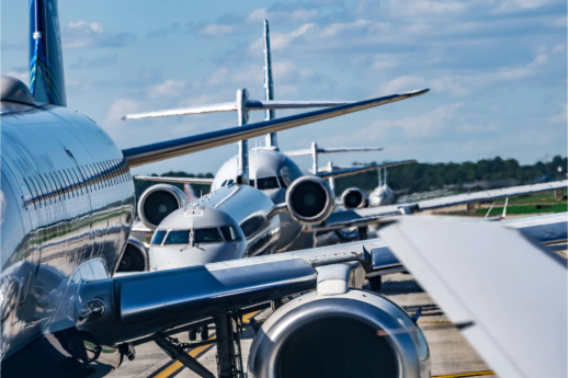 Airplanes lined up on the tarmac.