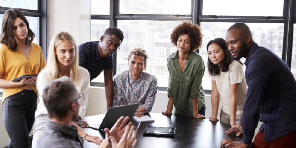 A diverse group of colleagues gathered around a conference table.