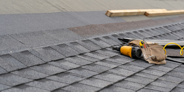 Roofing tools lie on a rooftop