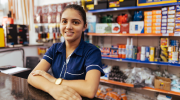 A young woman stands at the counter of a hardware store. 