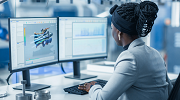 An African American female engineer works on her computer.