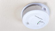 A carbon monoxide detector on the ceiling. 