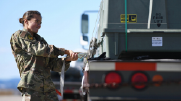 An airman secures a munitions kit to a flatbed truck at Ellsworth Air Force Base, South Dakota. 