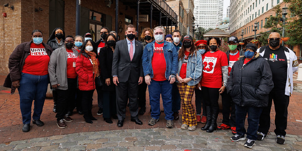 Secretary Walsh and Deputy Secretary Su stand with workers wearing Unite Here shirts in Louisiana. 