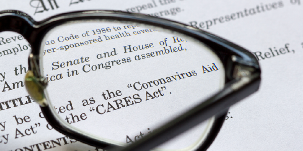 Glasses rest atop a printout of the Coronavirus Aid, Relief and Economic Security Act. 