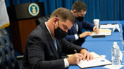 Secretary Walsh and Secretary Buttigieg sign an MOU at the Labor Department.