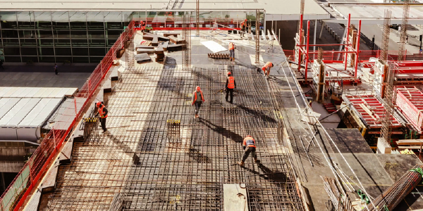 Construction workers in safety equipment viewed from above. 