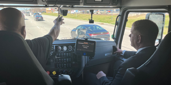 Secretary Walsh rides shotgun in the cab of a truck driven by Steve Fields.