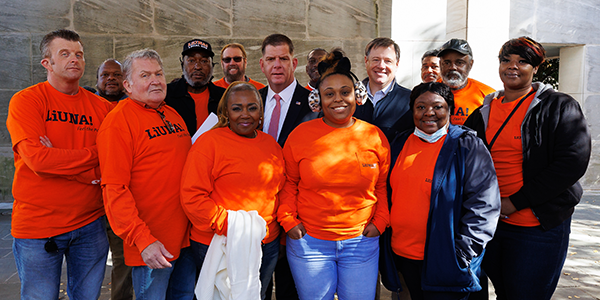 Secretary Walsh stands with a group of workers wearing LiUNA shirts.