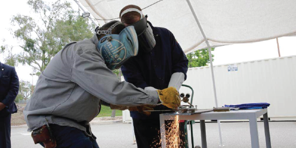 Secretary Walsh and a young welder.