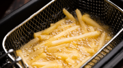 French fries in a fryer basket.