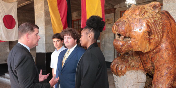 Secretary Walsh chats with students outside a university