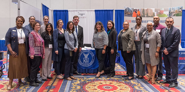 Labor Secretary Marty Walsh and Womenâs Bureau Director Wendy Chun-Hoon with a diverse group of workers and union leaders in front of the Labor Department booth at the NABTU Tradeswomen Build Nations conference.