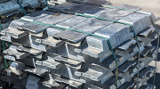 A large stack of aluminum billets in a smelter factory.