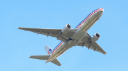 Image of an American Airlines plane rising into a clear sky.