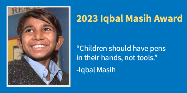 Image shows a pre-teen boy smiling in a classroom. Text reads: 2023 Iqbal Masih Award. 