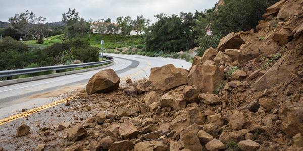 A landslide caused by a winter storm blocks a road in California.