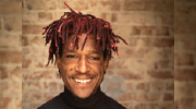 Headshot of Jacob in a black chef jacket with white text reading Cooking up Success