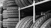 Tires stacked on metal shelves.