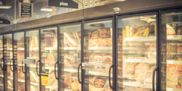Frozen pizzas displayed in a supermarketâs frozen food section.