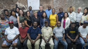 A group shot of two dozen people posing for a photo.