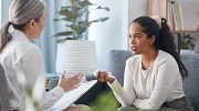 A young woman speaks with her psychologist.