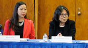 Acting Secretary of Labor Julie Su and another woman sit at a table during a roundtable discussion.