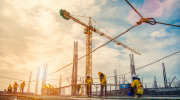 A construction site with cranes rising toward the sky.