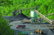 Heavy machinery in movement at a mining site.