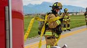 A firefighter unrolls a hose. Credit: U.S. Air Force photo by Senior Airman Jessica Blair via DVIDS.