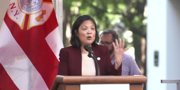 Julie Su speaks at a podium in New York City. 