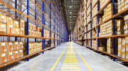 Rows of shelves holding boxes in a warehouse distribution center.