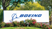 A Boeing sign rises above a row of rose bushes.