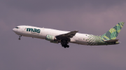 Photographed from below, a MAS Air plane ascends into the clouds. 