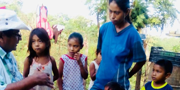 A surveyor speaks with a woman in rural Mexico. They are surrounded by small children. Source: Mexicos National Institute of Statistics and Geography/INEGI