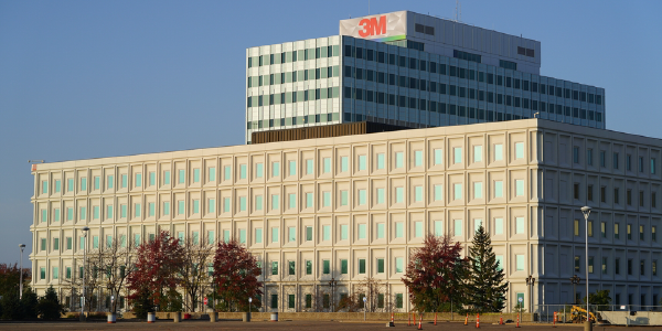 Exterior of a 3M building in winter, with the company's logo visible on the top floor.