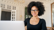 A young woman works on a laptop.