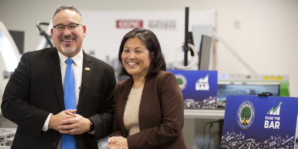 Secretary of Education Miguel Cardona and Acting Secretary of Labor Julie Su pose for a photo at CCAC's Center for Education, Innovation, and Training.