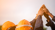 Several workers join raised hands in a sign of solidarity.