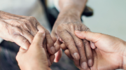 Close-up of two people clasping hands