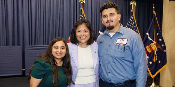 Acting Secretary Su smiles for a photo with two young apprentices in the Labor Departmentâs headquarters. 