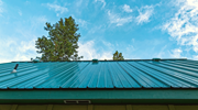 An aluminum roof against a blue sky, shown from a low angle. 