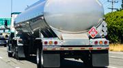 Close-up of an oil tanker trailer driving on the highway, seen from the back. 