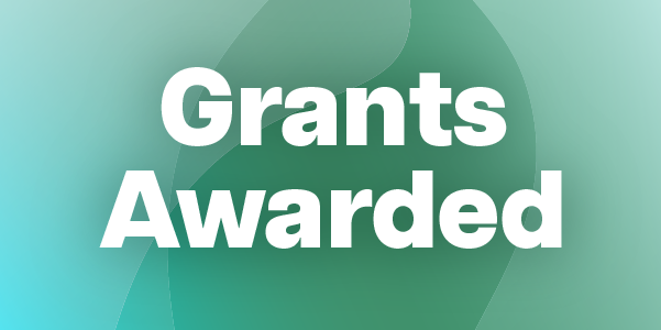 White text reading “Grants Awarded” on a green abstract background. 