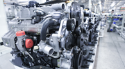 Car engines being assembled in a manufacturing facility.